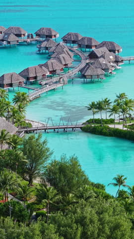 Bora Bora Island, French Polynesia. Vertical Aerial View of Luxury Resort Villas Over Turquoise Water of Lagoon
