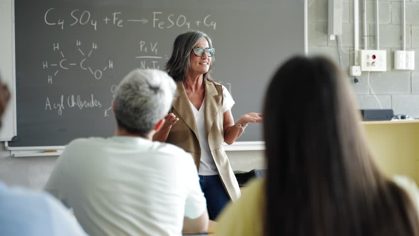 University students listening to passionate female professor delivering motivational science lecture speech at College