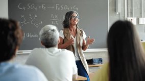 University students listening to passionate female professor delivering motivational science lecture speech at College - Powered by Shutterstock - Get 15% off with code: PIKWIZARD15