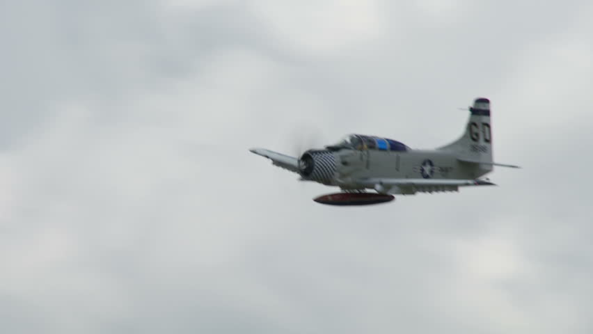 US Navy Douglas Skyraider historic war plane flying in a cloudy sky.  Recorded