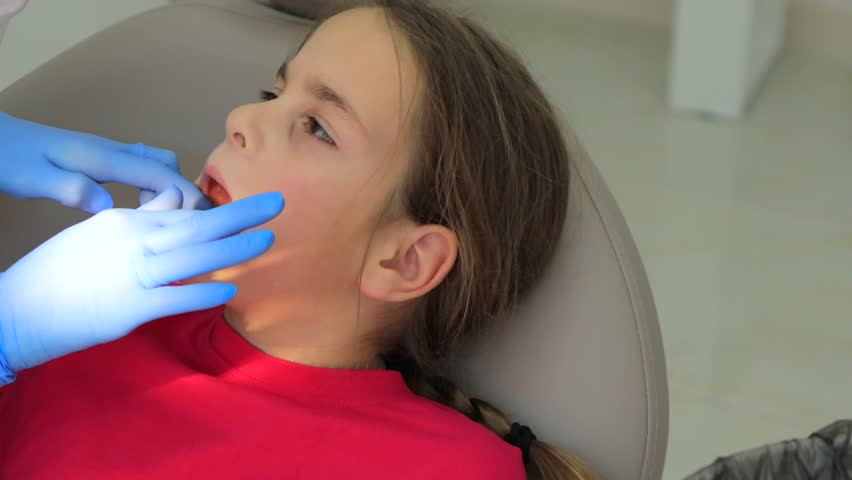 Girl getting dental impression taken during orthodontic consultation. High quality 4k footage