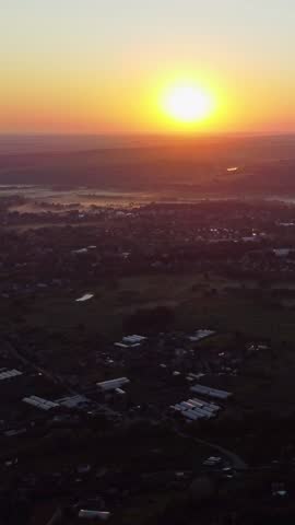 Aerial sunrise view with rural landscape and farmland in morning light