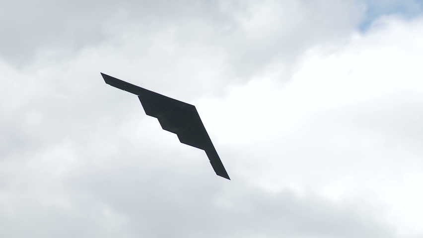 Northrop B-2A Spirit stealth bomber flying slowly overhead.