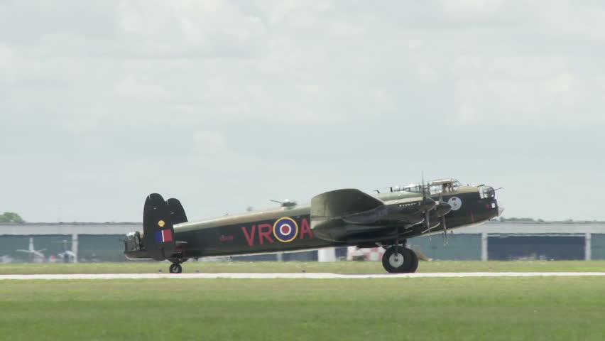 Avro Lancaster bomber plane from World War II taxiing at an airfield (no audio).