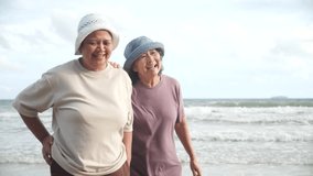 Elderly women wearing hats enjoy summer activity beach with joyful laughter embracing tourism travel concept for friendship happiness by ocean waves cloudy sky creating warm joyful moment by sea - Powered by Shutterstock - Get 15% off with code: PIKWIZARD15