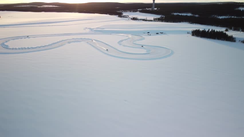 Race track on a Frozen Lake in Finland during golden hour – Aerial Winter Landscape high altitude