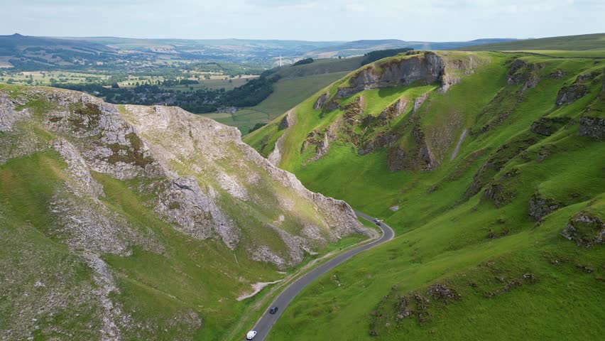 Picturesque aerial drone view of idyllic Winnats Pass. A mountain pass and a winding road. Derbyshire, England, UK