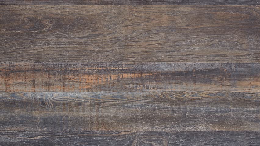 Camera slowly zooms into worn dining tabletop, revealing rich rustic grain