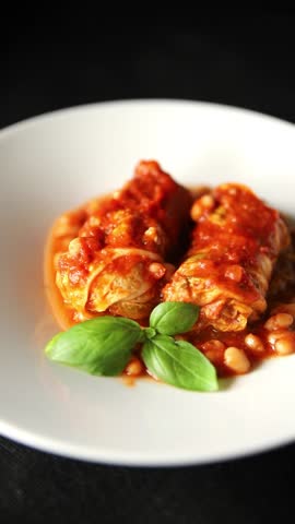 Stuffed cabbage tomato sauce with beans meat, cabbage, fresh delicious gourmet food background on the table rustic food top view copy space