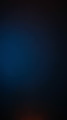 Dynamic orange smoke rising on dark blue background creating warm cold contrast for text reveal abstract vertical video