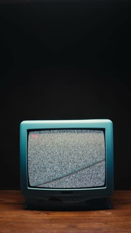 Retro TV, vintage television In a nostalgic setup, a retro TV displays grain on screen, scary halloween night device good for chroma key and green screen.