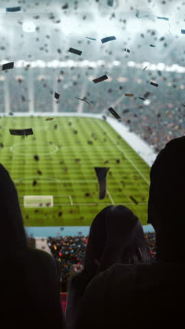 Vertical Shot of Soccer Fans Celebrating Victory in Stadium with Flags and Confetti