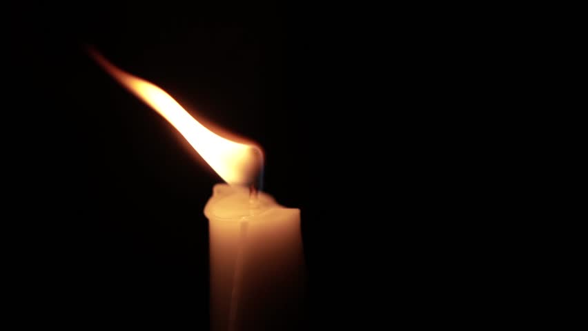 Close-Up of a Burning Candle Flame in the Dark