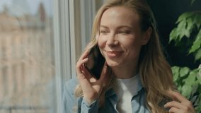 Playful flirty Caucasian woman girl client talking phone standing look window beautiful female businesswoman touching hair speaking smartphone call online cellphone talk boyfriend friends home office - Powered by Shutterstock - Get 15% off with code: PIKWIZARD15