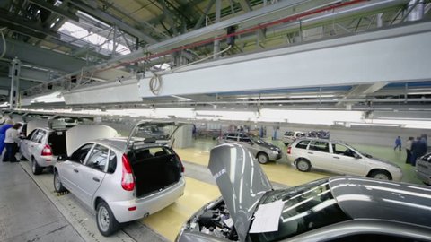 TOGLIATTI - SEP 30: New Lada Kalina cars stand on conveyor at factory VAZ, (shown in motion) on September 30, 2011 in Togliatti, Russia. AvtoVAZ Group made profit 29,2 billion rubles on result of 2012
