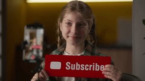 Happy little girl blogger filming video blog showing thumbs up subscribe sign button at home cheerful Caucasian child kid gesturing influencer recording vlog mobile phone camera tripod like recommend - Powered by Shutterstock - Get 15% off with code: PIKWIZARD15