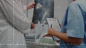 Doctor entering exam room lifting pelvic X-ray for analyzing health data with oscillating graph. Medical, healthcare, analysis, diagnostics, professionalism, clinical, innovation - Powered by Shutterstock - Get 15% off with code: PIKWIZARD15