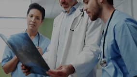 Medical team examining X-ray film initiating digital graph overlay for diagnosis in corridor. Healthcare, collaboration, data visualization, analytics, medical technology, professional, diagnostic - Powered by Shutterstock - Get 15% off with code: PIKWIZARD15