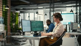 Female executive consultant listening to songs on headphones at the workstation, managing administrative tasks to ensure company productivity and efficiency. Woman reviews data. Camera A. - Powered by Shutterstock - Get 15% off with code: PIKWIZARD15