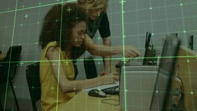 Instructor approaching student in computer lab pointing out screen details while jotting notes. Collaboration, education, mentorship, digital, training, focus, workplace - Powered by Shutterstock - Get 15% off with code: PIKWIZARD15
