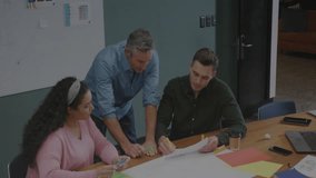 Team exchanging markers and sketching design, holographic globe animating above in business meeting. Collaboration, innovation, digital, brainstorming, technology, teamwork, office - Powered by Shutterstock - Get 15% off with code: PIKWIZARD15