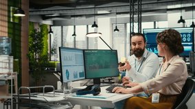 Business partners engaging in a discussion about financial forecasting and data insights, cheerful teamwork in a modern workspace. Man and woman ensuring goals achievement. Camera B. - Powered by Shutterstock - Get 15% off with code: PIKWIZARD15