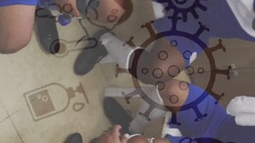 Coronavirus concept icons against team of male soccer players forming a huddle in locker room. sports and covid-19 pandemic concept - Powered by Shutterstock - Get 15% off with code: PIKWIZARD15