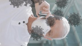 Animation of covid 19 cells over senior man wearing face mask. global covid 19 pandemic and vaccination concept digitally generated video. - Powered by Shutterstock - Get 15% off with code: PIKWIZARD15