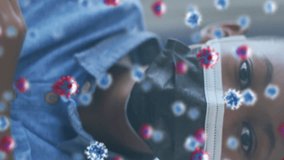 Animation of covid 19 cells over african american schoolboy in face mask. global covid 19 pandemic and education concept digitally generated video. - Powered by Shutterstock - Get 15% off with code: PIKWIZARD15