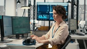 Office administrator uses focus music on headset to solve tasks, monitoring performance metrics at the workstation. Administrative tasks to ensure enterprise productivity and success. Camera B. - Powered by Shutterstock - Get 15% off with code: PIKWIZARD15