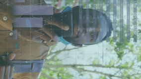 Animation of data processing over african american men wearing face mask using smartphone. Global science, connections, data processing and digital interface concept digitally generated video. - Powered by Shutterstock - Get 15% off with code: PIKWIZARD15