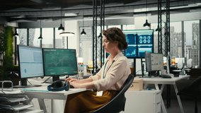 Office administrator uses focus music on headset to solve tasks, monitoring performance metrics at the workstation. Administrative tasks to ensure enterprise productivity and success. Camera A. - Powered by Shutterstock - Get 15% off with code: PIKWIZARD15