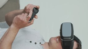 Animation of social media data processing over caucasian man using vr headset. Global computing, digital interface and data processing concept digitally generated video. - Powered by Shutterstock - Get 15% off with code: PIKWIZARD15