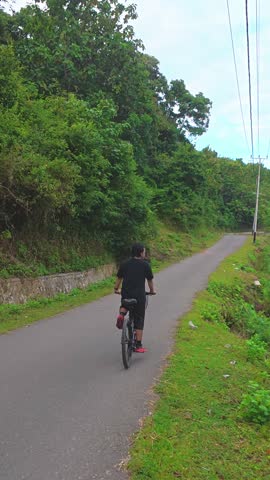 Man Riding Bicycle on Road Outdoors