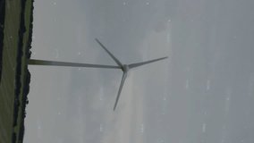 Wind turbine in countryside with financial data processing animation overlay. Renewable, energy, sustainability, finance, technology, innovation - Powered by Shutterstock - Get 15% off with code: PIKWIZARD15