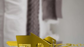 Animation of gold house key fob and key hanging in front of blurred house with sold sign. Christmas tradition and celebration concept digitally generated video. - Powered by Shutterstock - Get 15% off with code: PIKWIZARD15