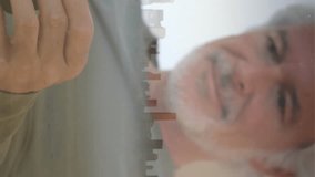 Animation of media icons and cityscape over senior caucasian man using smartphone. Social media and digital interface concept digitally generated video. - Powered by Shutterstock - Get 15% off with code: PIKWIZARD15