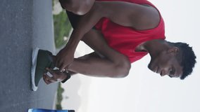 Animation of like icon with increasing number over african american man tying shoelace on road. Digital composite, athlete, exercise, fitness, bottle, social media, notification, feedback, sky. - Powered by Shutterstock - Get 15% off with code: PIKWIZARD15