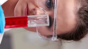 Animation of dna helix over close up of caucasian woman shaking liquid filled test-tube. Digital composite, multiple exposure, molecule, anatomy, medical, healthcare and technology concept. - Powered by Shutterstock - Get 15% off with code: PIKWIZARD15