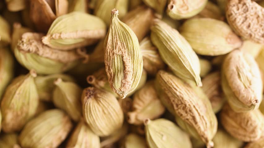 top view close up green cardamom seeds rotating background
