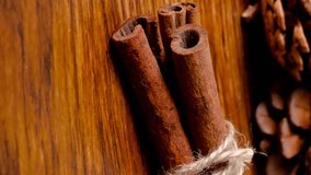 Animation of christmas decorations, cinnamon, pine cones and copy space on wooden background. christmas, tradition and winter celebration concept digitally generated video. - Powered by Shutterstock - Get 15% off with code: PIKWIZARD15