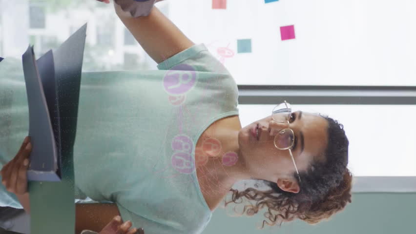 Reviewing documents, diverse team with digital network animation overlay in office. Teamwork, collaboration, diversity, technology, business, innovation - Powered by Shutterstock - Get 15% off with code: PIKWIZARD15