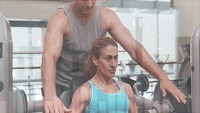 Trainer adjusting chest-press handles and guiding woman pressing weights for alignment in gym. Fitness, strength, training, gym, health, workout, resistance - Powered by Shutterstock - Get 15% off with code: PIKWIZARD15