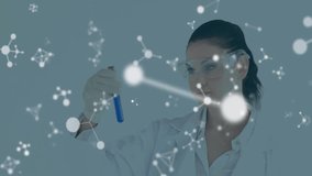 Female research scientist raising, tilting test tube and inspecting liquid with molecular graphics. Scientist, laboratory, research, analytics, innovation, diagnostics, visualization - Powered by Shutterstock - Get 15% off with code: PIKWIZARD15