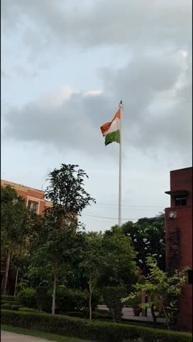 India flag flying high at Connaught Place with pride with plain white background, India flag fluttering, Indian Flag on Independence Day and Republic Day of India, tilt up shot, Har Ghar Tiranga