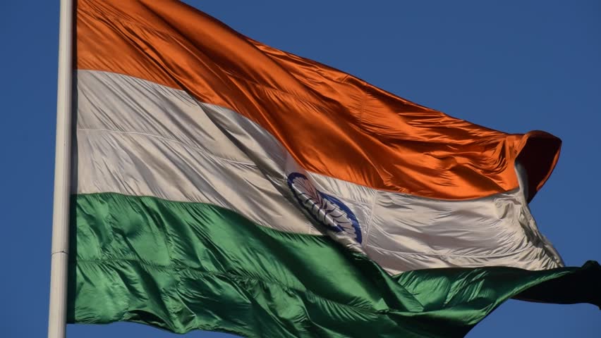 India flag flying high at Connaught Place with pride with plain white background, India flag fluttering, Indian Flag on Independence Day and Republic Day of India, tilt up shot, Har Ghar Tiranga