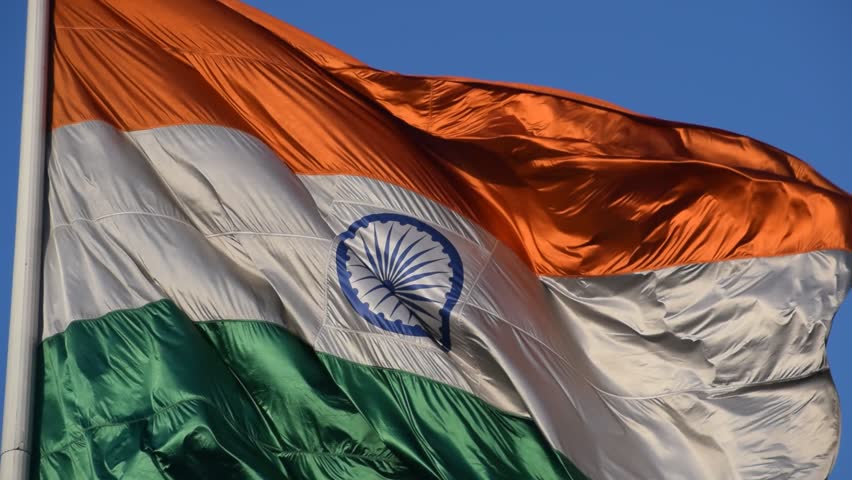 India flag flying high at Connaught Place with pride with plain white background, India flag fluttering, Indian Flag on Independence Day and Republic Day of India, tilt up shot, Har Ghar Tiranga