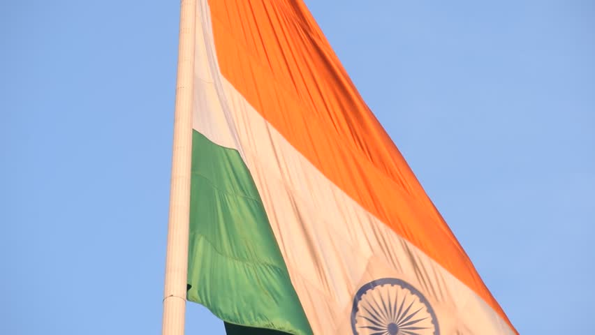 India flag flying high at Connaught Place with pride with plain white background, India flag fluttering, Indian Flag on Independence Day and Republic Day of India, tilt up shot, Har Ghar Tiranga