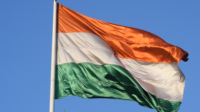 India flag flying high at Connaught Place with pride with plain white background, India flag fluttering, Indian Flag on Independence Day and Republic Day of India, tilt up shot, Har Ghar Tiranga