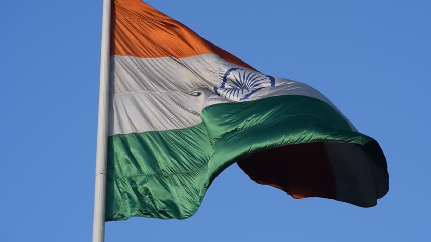 India flag flying high at Connaught Place with pride with plain white background, India flag fluttering, Indian Flag on Independence Day and Republic Day of India, tilt up shot, Har Ghar Tiranga